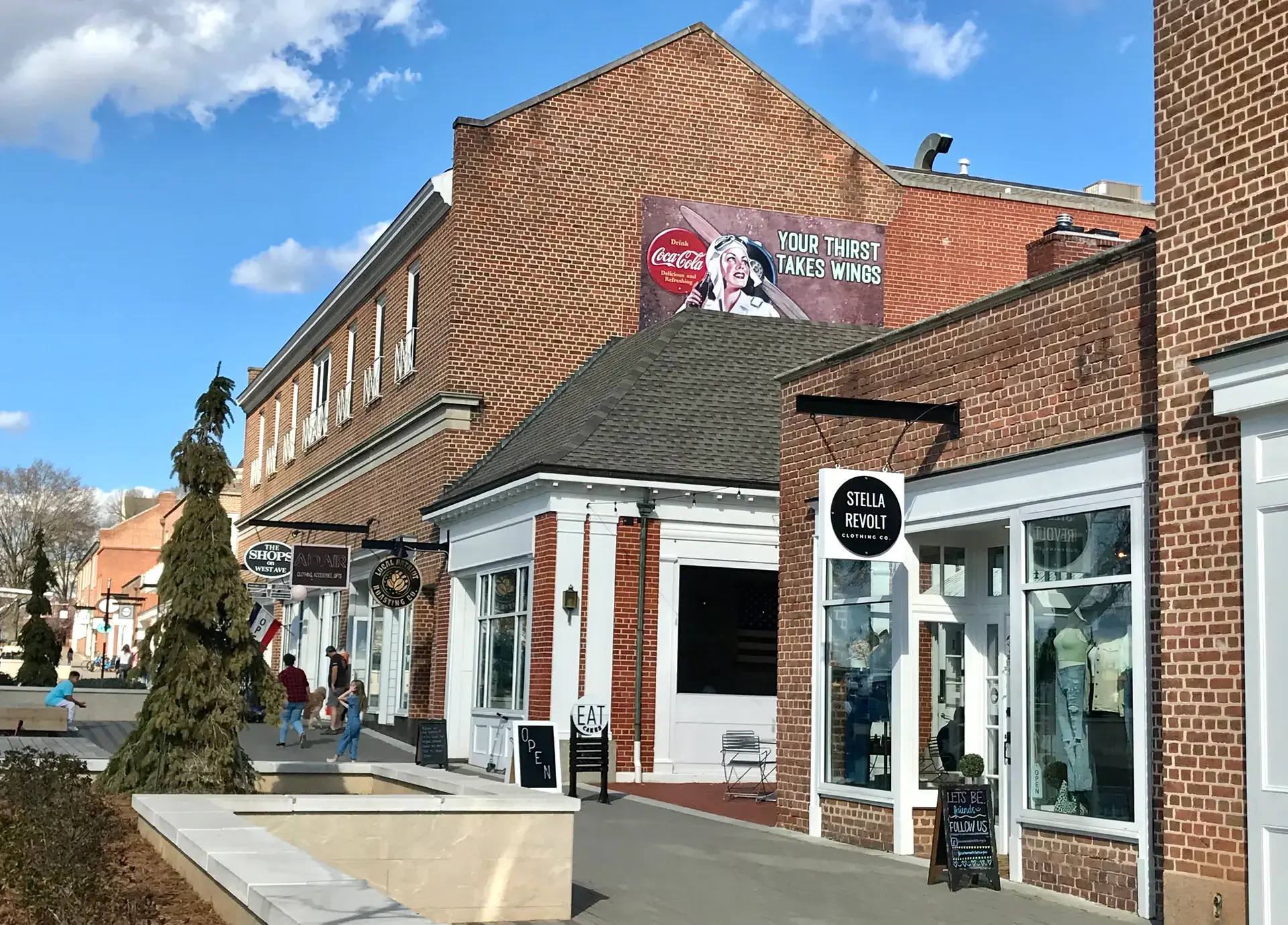 Brick shops and a vintage Coca-Cola mural on West Avenue in downtown Kannapolis, NC