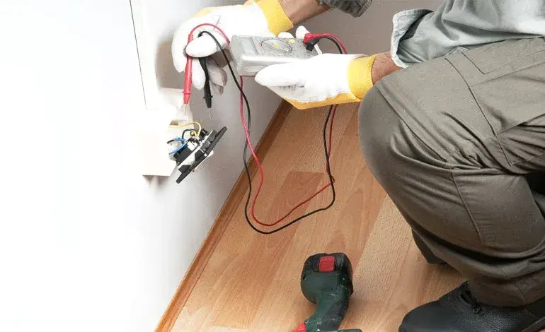Roland Black electrician testing a newly wired outlet after a panel installation in Gastonia, NC