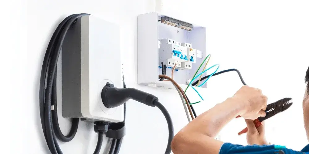 Electrician wiring a Level 2 EV charger to a dedicated circuit in Gastonia, NC