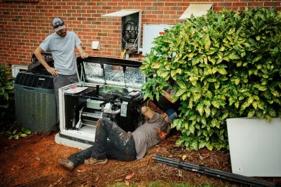 Roland Black technicians installing a standby generator at a brick home in Gastonia, NC
