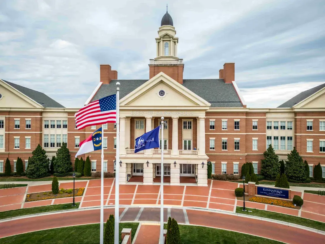 Brick City Hall with a white cupola and flags in Kannapolis, NC Brick City Hall with a white cupola and flags in Kannapolis, NC